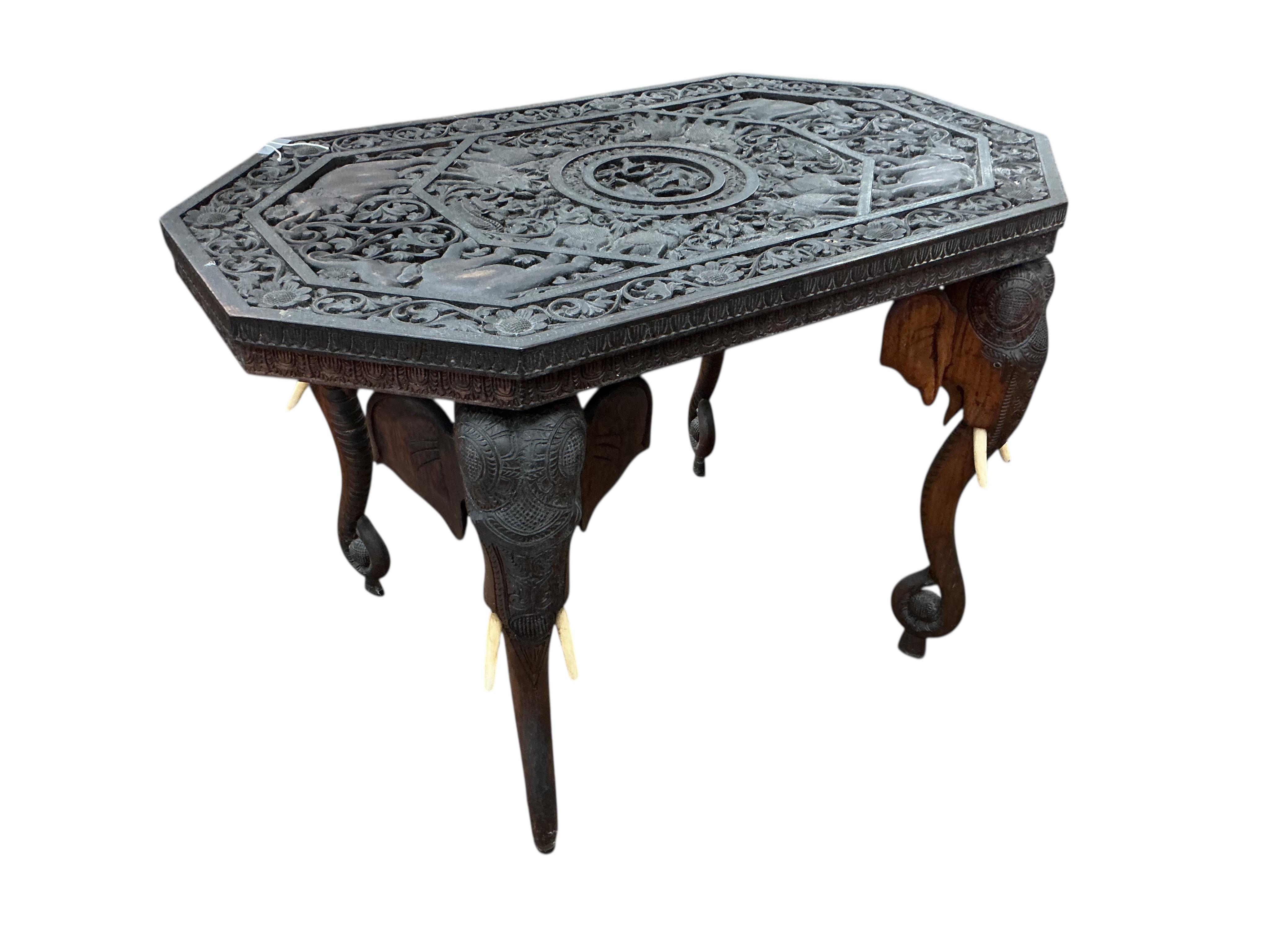 An Indian octagonal carved hardwood occasional table, width 91cm, depth 54cm, height 61cm